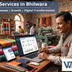 A local business owner using a laptop in a textile workshop, representing the Best IT Services in Bhilwara provided by WorthyTech Solutions.
