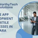 Promotional banner for WorthyTech Solutions advertising "Mobile App Development for Textile Businesses in Bhilwara," featuring a business professional using a smartphone on a modern textile factory floor.